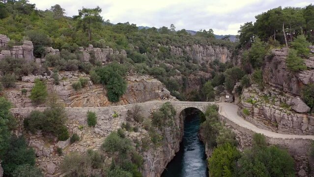 Old stone bridge in Koprulu canyon over K&ouml;pr&uuml;&ccedil;ay river, drone video, aerial view. Antalya, Turkey