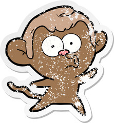 distressed sticker of a cartoon surprised monkey