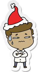 hand drawn sticker cartoon of a anxious man wearing santa hat