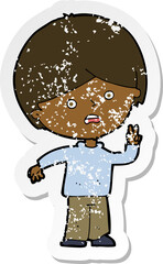 retro distressed sticker of a cartoon unhappy boy giving peace sign