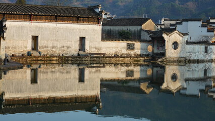 The beautiful traditional Chinese village view with the classical architecture and fresh green trees as background