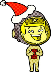 hand drawn comic book style illustration of a laughing astronaut wearing santa hat