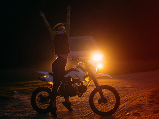 Fototapeta na wymiar Slim young woman on motocross motorcycle