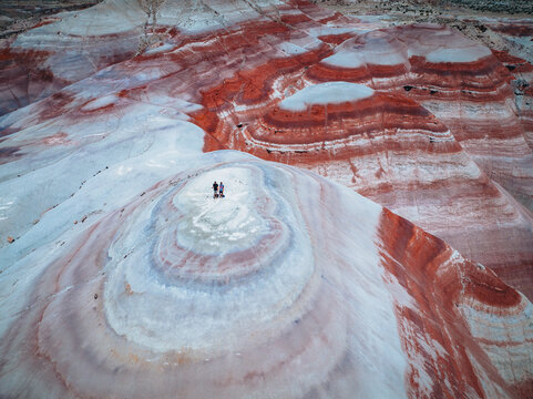 bentonite hills Amazing aerial view. Two tourists looking at camera. Located in Capitol Reef National Park, United States, Utah.