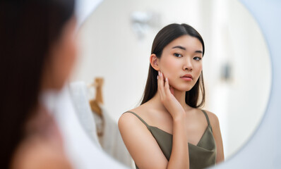 woman looking at mirror