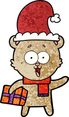 laughing teddy  bear with christmas present