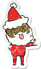 man with beard sticking out tongue wearing santa hat