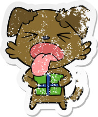 distressed sticker of a cartoon dog with christmas present