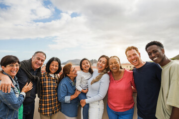 Group of multigenerational friends smiling in front of camera - Multiracial friends of different...