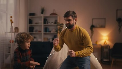 Young dad and his son having fun dancing together, happy parenting and childhood