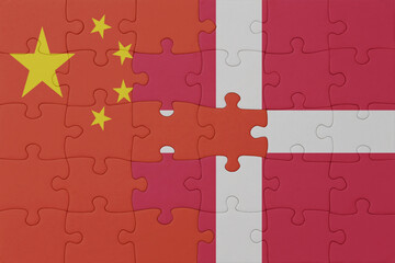 puzzle with the national flag of denmark and china . macro.concept.