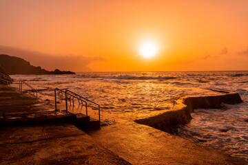 Fototapeta na wymiar Sunset at the natural pools of La Maceta in El Hierro, Canary Islands