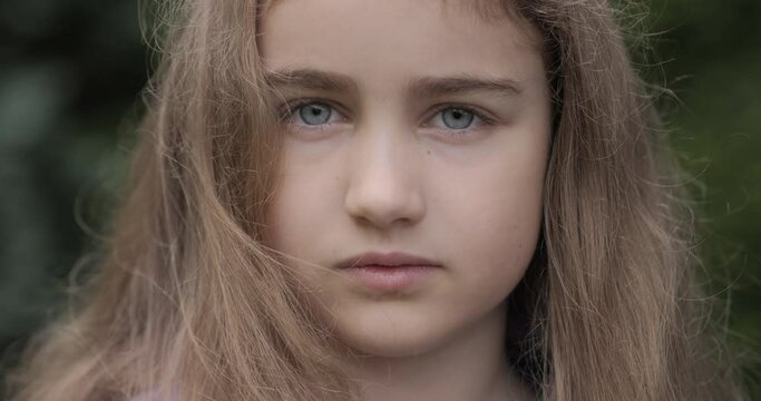 Portrait Cute Serious Child Serious Pensive Worried Caucasian Teenager. Sad Confident Little Kid Girl. Human Face. Young Serious Teenage Girl With Blonde Long Hair Look at Camera. 