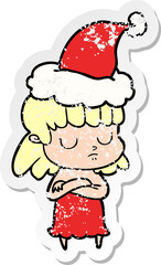 hand drawn distressed sticker cartoon of a indifferent woman wearing santa hat