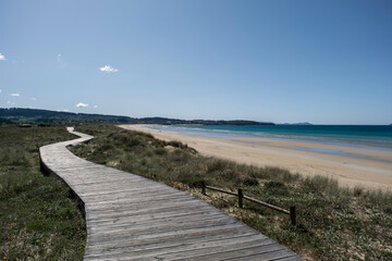 Fototapeta na wymiar Wooden walkway on the beach dunes