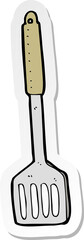 sticker of a cartoon kitchen spatula
