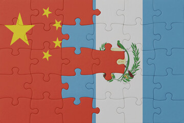 puzzle with the national flag of guatemala and china . macro.concept.