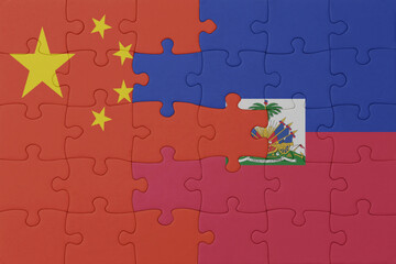 puzzle with the national flag of haiti and china . macro.concept.