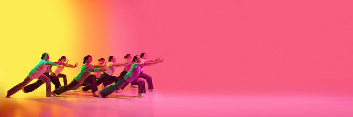 Banner with dance team of young adorable girls moving to the beat of the music on pink and yellow gradient background in neon light. Copy space for ad, text