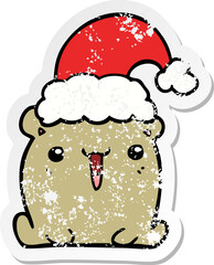 distressed sticker of a cute cartoon bear with christmas hat
