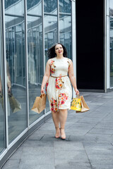 How to Shop for Summer Fashion on a Budget. Choosing the Right Fabrics for Hot and Humid Summer Weather. Outdoor portrait of stylish curvy woman with shopping bags