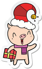 sticker of a happy cartoon pig with xmas present