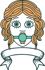 traditional tattoo with banner of female face wearing a ball gag