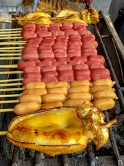 Grilled octopus on the stove, Grilling hot dogs (Sausages) on skewers, Full-body fresh cuttlefish on charcoal grill, Barbecue (BBQ), Favourite Thailand street food, Delicious street food.