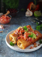 A typical dish of Mexican cuisine - Chimichanga, made of tortilla with different ingredients
