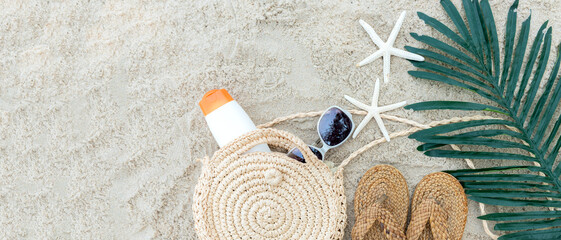 Summer Fashion woman sunblock with accessories item go to travel in the beach. Tourism travel on holiday happy leisure and destination trip.  Sand beach background. copy space for banner