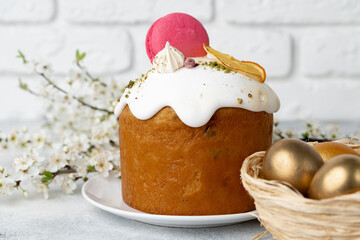 Easter cake and golden eggs on table