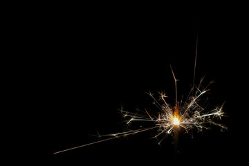 A burning sparkler with black background