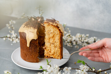 Hand holding piece of Easter cake on dessert spatula