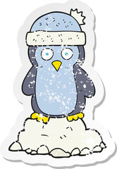 retro distressed sticker of a cartoon penguin wearing hat