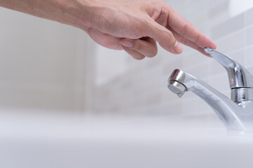 Save water. Volunteer keeps turning off the running water in the bathroom to protect environment. Greening planet, reduce global warming, Save world, life, future, risk energy, crisis , water day