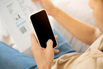 business man use phone to scan barcode or QR codes to pay credit card bill after receiving document invoice online. payment, receive, paying electricity, digital payments without money, technology