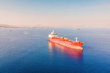 Aerial view of industrial crude oil fuel tanker ship anchored in deep blue