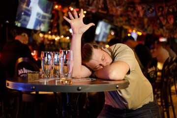 a man in a bar drank a lot and tries to order a beer in a dream