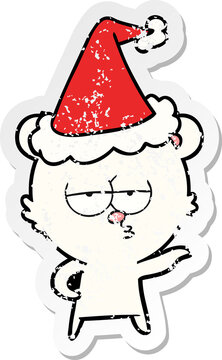 bored polar bear hand drawn distressed sticker cartoon of a wearing santa hat