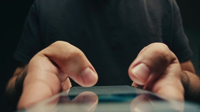 Man chatting online on phone smartphone macro close up, typing text message, touching touchscreen keyboard, using messenger application. Person holding mobile phone, close up, swiping social media. 