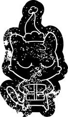 cute quirky cartoon distressed icon of a cat wearing santa hat