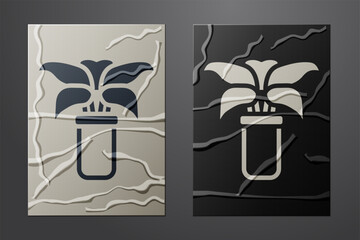 White Exotic tropical plant in pot icon isolated on crumpled paper background. Paper art style. Vector