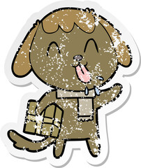 distressed sticker of a cute cartoon dog with christmas present