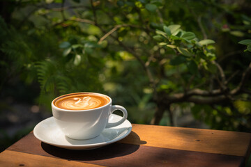 Background Coffee cup and beans on old kitchen table. Coffee cup in coffee shop.