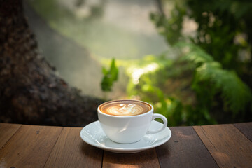 Background Coffee cup and beans on old kitchen table. Coffee cup in coffee shop.
