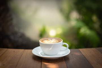Background Coffee cup and beans on old kitchen table. Coffee cup in coffee shop.