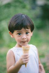 Asia boy he mouth aftertaste from eating chocolate ice cream  or chocolate dessert. A