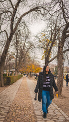 Obraz premium Latin woman walking in El Retiro park in Madrid.
