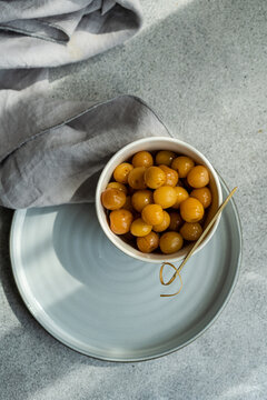 Overhead view of a bowl of sweet white pickled cherries
