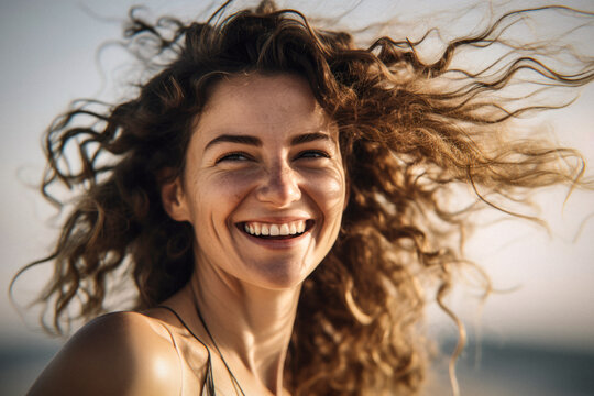 portrait of a fictional woman smiling, on the beach during sunset